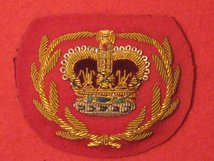 NUMBER 1 DRESS RQMS CROWN AND LAUREL WREATH GOLD ON SCARLET BADGE.