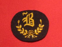 NUMBER 1 DRESS B TRADE BADGE GOLD ON BLACK BADGE